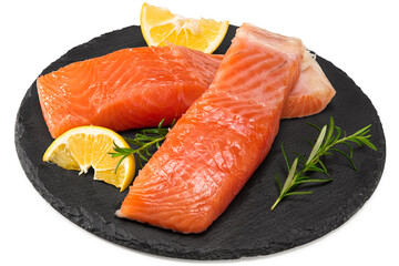 Red fish. Raw salmon fillet with rosemary and lemon on black round stone plate isolate on white background. Clipping path and full depth of field