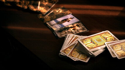 Blurred tarot cards on the table, esoteric concept, fortune telling predictions