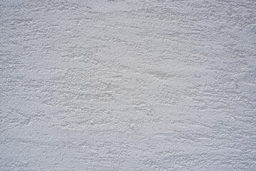 Simple white rough plaster wall for background.