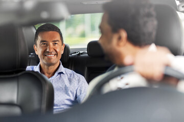 transportation, vehicle and people concept - happy smiling middle aged male passenger talking to...