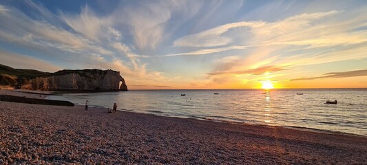 Etretat cliffs in the sunset colours on a hot summer day