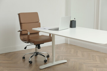 Director's office with large wooden table and comfortable armchair. Interior design