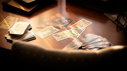 Blurred tarot cards on the table, esoteric concept, fortune telling predictions