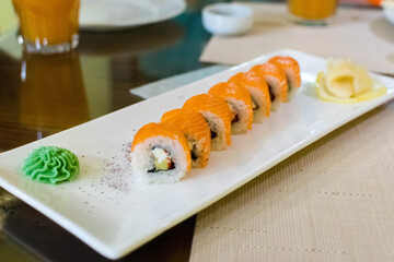 Sushi roll (Philadelphia) with salmon, smoked eel, avocado, cream cheese