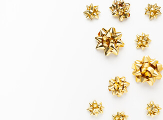 Christmas or New Year composition with gold sparkling ribbon decorations on white background. Flat lay, copy space.