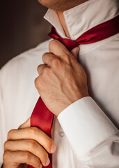 businessman adjusting tie