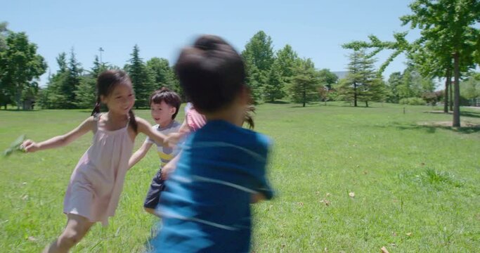 Happy children playing on meadow,4K