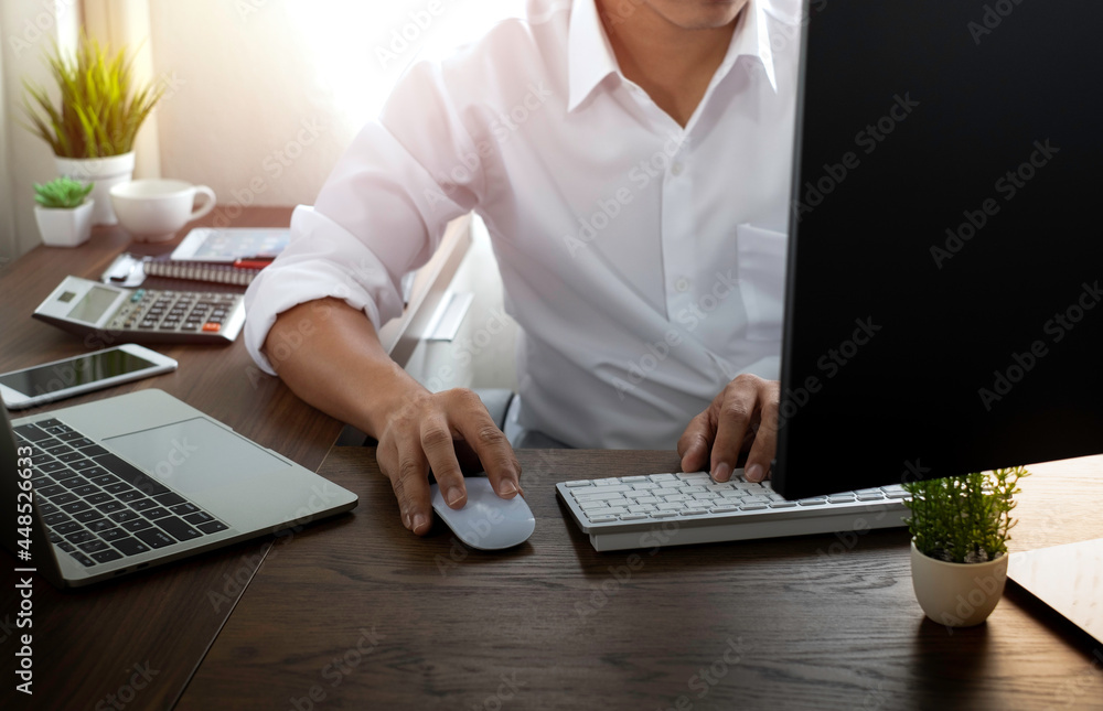 Poster image of man hand using and typing keyboard computer with laptop on office desk. workspace, business