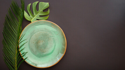 Empty green plate on black background. Luxury dinner plate served with asian kinfolk grunge style...