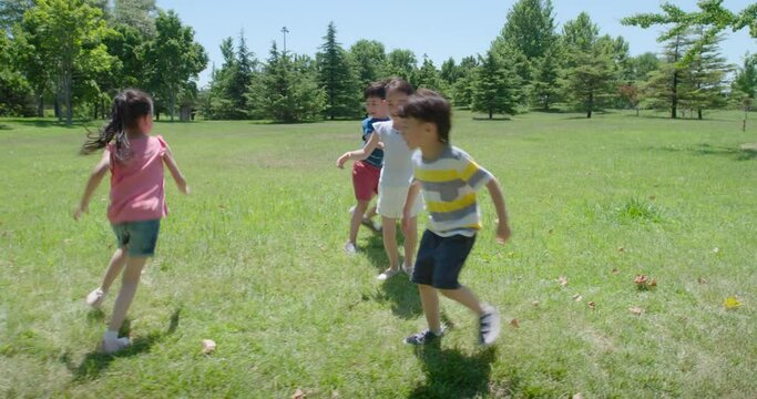 Happy children playing on meadow,4K