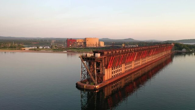 The Historical Iron Ore Dock on the shore of Lake Superior in Marquette, Michigan at sunrise. Aerial view of Presque Isle Dock in Marquette's Upper Harbor. Beautiful sunrise light
