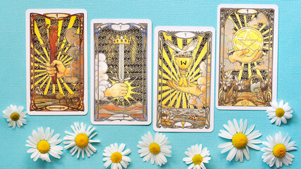 Golden tarot cards on the Blue background with Daisy flowers, four aces - obrazy, fototapety, plakaty