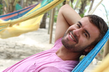 Guy enjoying a hammock in topical island