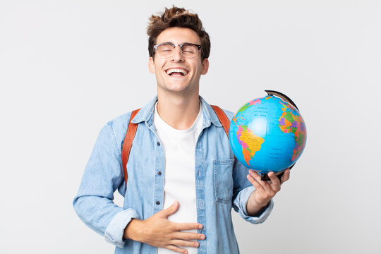 young handsome man laughing out loud at some hilarious joke. student holding a world globe map