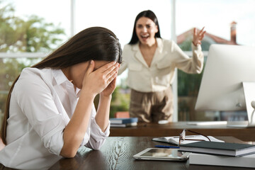 Boss screaming at employee in office. Toxic work environment - obrazy, fototapety, plakaty