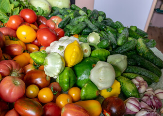 color photo with autumn vegetables on the table, different colors, shapes and types of vegetables prepared for home canning, autumn harvest time