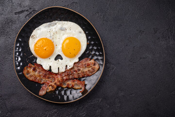 Fried eggs in the shape of a skull. Halloween healthy breakfast