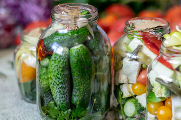 glass jars with different colors, types, shapes of vegetables, vegetables prepared for home canning, autumn harvest time