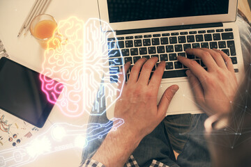 Double exposure of man's hands typing over computer keyboard and brain hologram drawing. Top view. Ai and data technology concept.