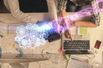 Double exposure of man and woman working together and data theme hologram drawing. Computer background. Top View.