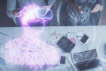 Double exposure of man and woman working together and man in virtual glasses hologram drawing. Computer background. Top View. VR, AR concept.