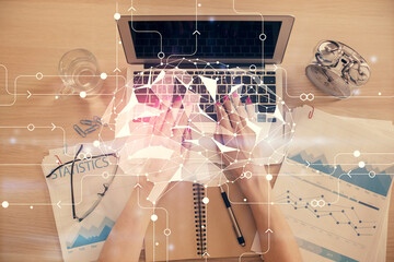 Double exposure of woman working on computer andhuman brain hologram drawing. Top View. Ai concept.