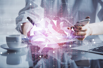 Double exposure of brain sketch hologram and woman holding and using a mobile device.
