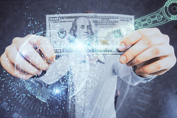 Double exposure of technology drawing hologram and us dollars bills and man hands. Data concept