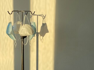 protective masks hanging from a hospital serum holder