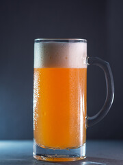 New England IPA craft beer glass on a dark gray concrete background