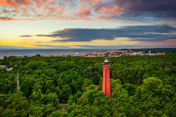 Red lighthouse on the Hel Peninsula at sunset. Poland.