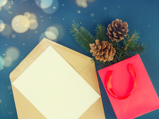 Beautiful greeting card. Holiday concept. Beautiful blue background next to it is a red bag with fir branches
