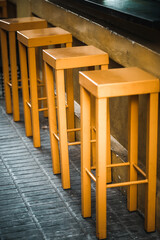 Fototapeta na wymiar Three yellow wooden stools