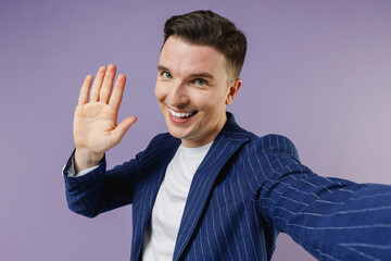 Close up young employee business man corporate lawyer 20s wear formal blue suit white t-shirt work in office meet greet waving hand as notice someone isolated pastel purple background studio portrait