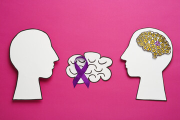 Human head cutouts, different brains and purple ribbon on crimson background, flat lay. Epilepsy...
