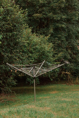 Street clothes dryer with clothespins on a pillar against a background of trees in Entremont, Haute-Savoie, France