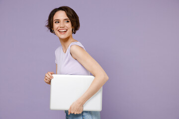Young side view smiling freelancer happy woman 20s with bob haircut wearing white t-shirt hold...