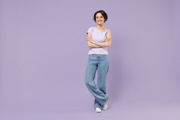 Full length young smiling happy woman 20s with bob haircut wear white t-shirt looking camera hold hands crossed folded isolated on pastel purple background studio portrait. People lifestyle concept