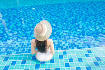 Fototapeta na wymiar Portrait beautiful young asian woman relax smile around outdoor swimming pool