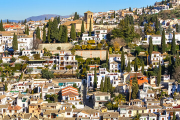 Fototapeta na wymiar Albaicin neighborhood in Granada with its old houses and churches. The Alhambra.