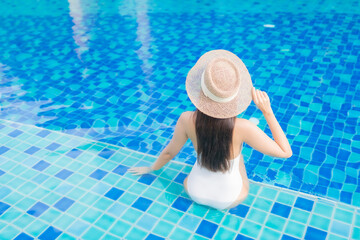 Portrait beautiful young asian woman relax smile around outdoor swimming pool