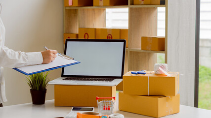 Starting a Small BusinessEntrepreneurship Asian SME work with boxes and laptops to take orders. At home, office, warehouse, online marketing package delivery, SME e-commerce concept.