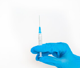 The doctor holds a vaccination syringe on a white background. A shot from the coronovirus....