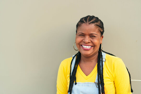 African Woman Outside The City, Looking At The Camera Smiling.