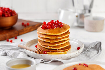 homemade pancakes with red currant honey. atmosphere of morning and breakfast. on white background
