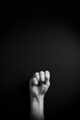 B&W image of hand demonstrating ASL sign language letter M with empty copy space
