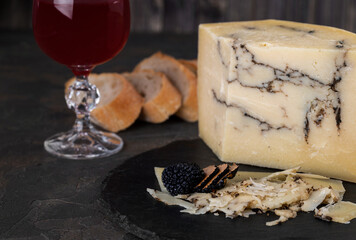 Italian hard cheese Pecorino romano with black truffle