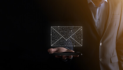 Businessman hand holding e-mail icon, Contact us by newsletter email and protect your personal...