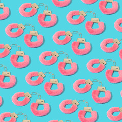 Colorful pattern with pink furry handcuffs on serenity pastel blue background.