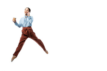 Ballerina with coffee to go talking on mobile phone and jumping isolated on white